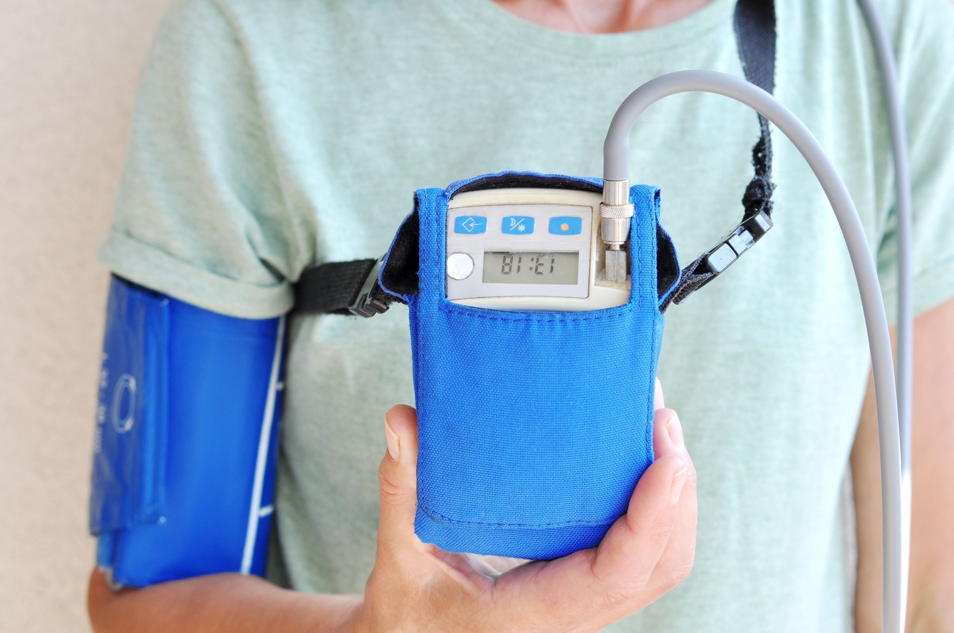 Woman wearing holter monitor device for daily monitoring of an electrocardiogram.